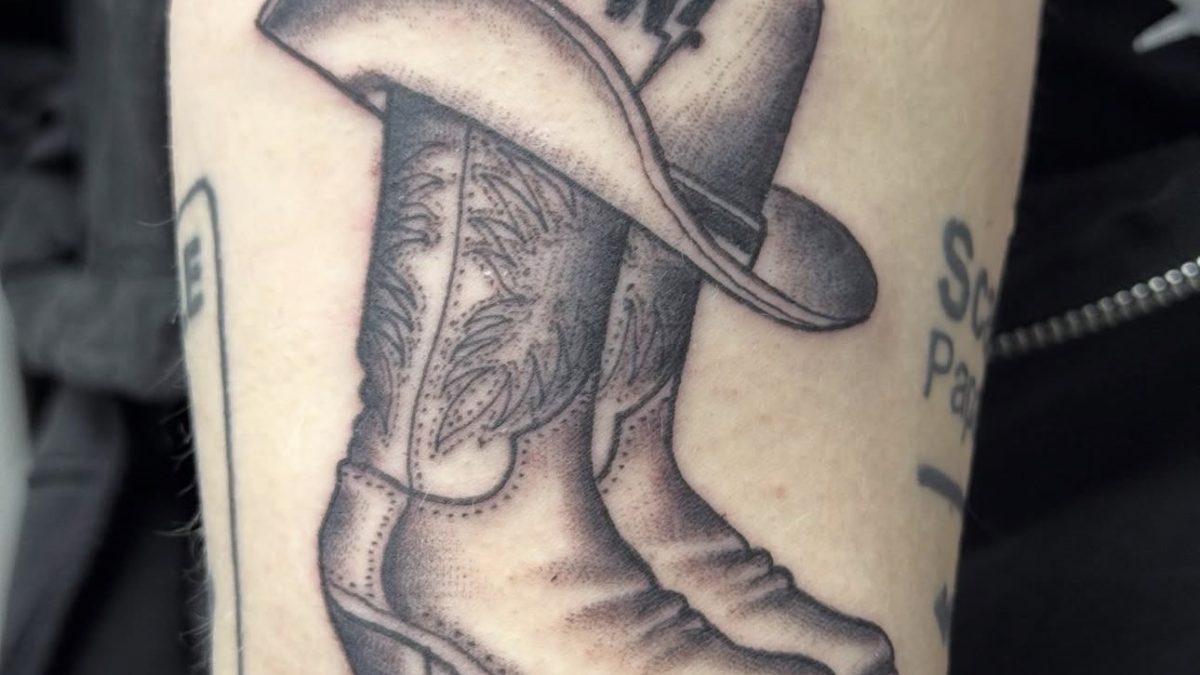 Black and grey cowboy boots with hat tattoo by Bones at Blood and Gold Tattoo Las Vegas
