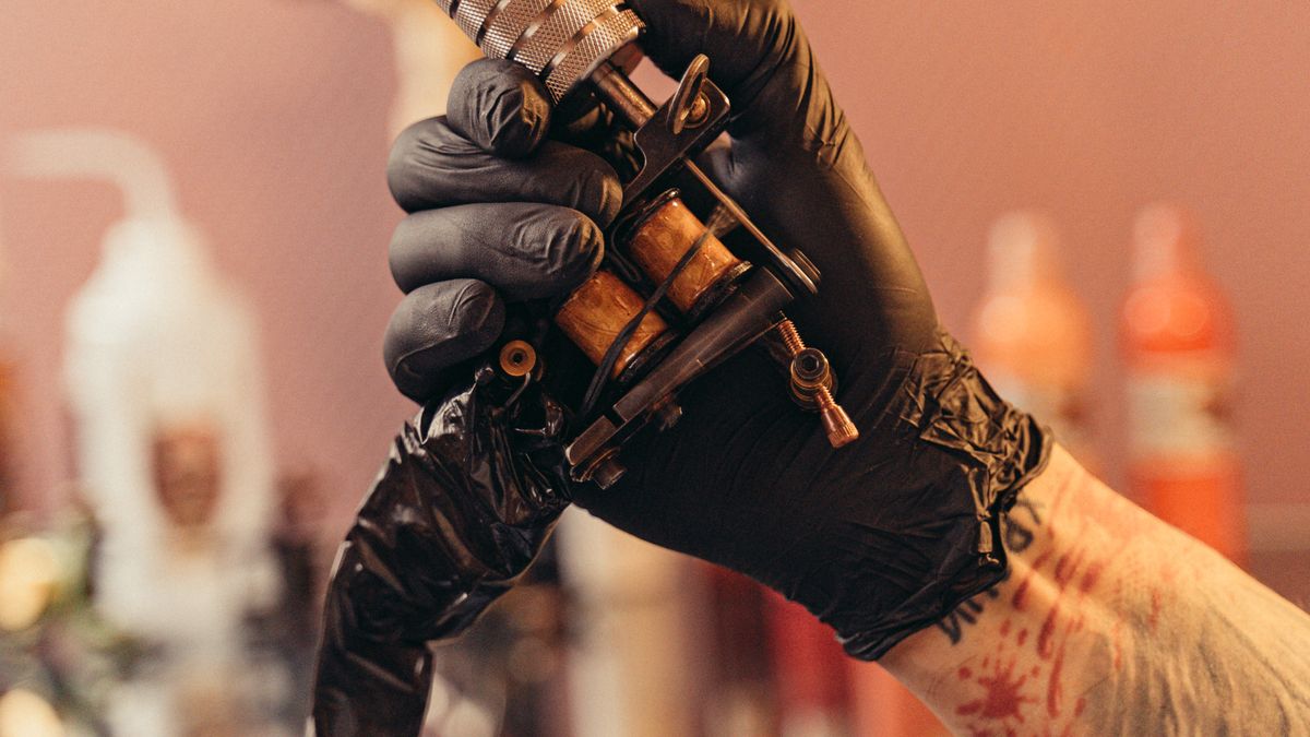 Tattoo artist working on a client during a full tattoo session