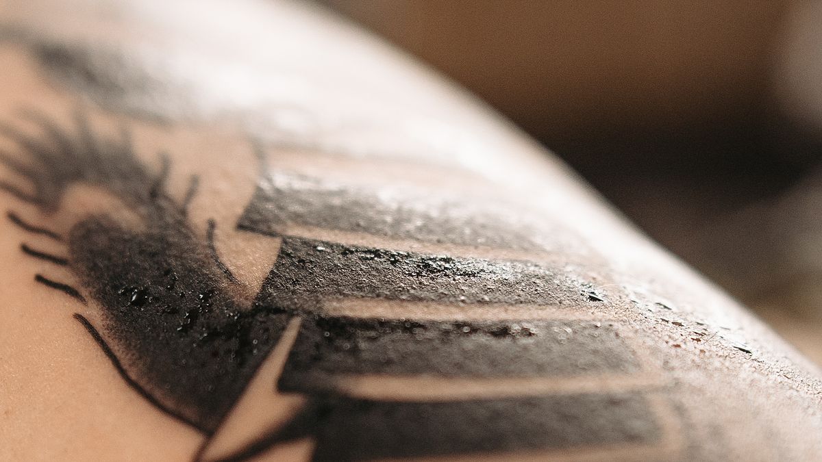 Close-up of healed black and grey tattoo artwork on skin